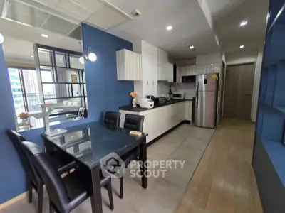 Modern kitchen with sleek design and dining area in open layout apartment