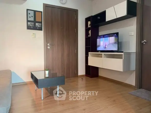 Modern living room with sleek furniture and wall-mounted TV, perfect for cozy relaxation.