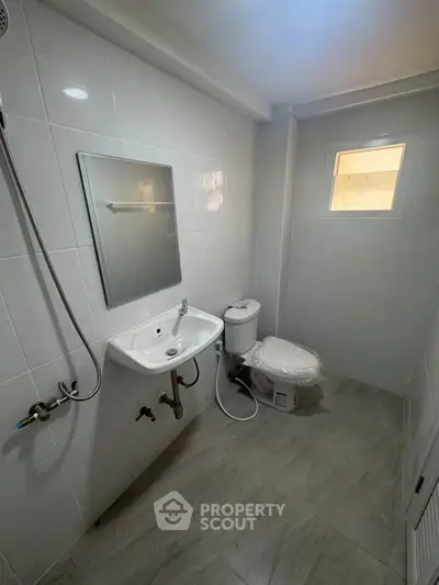 Modern bathroom with sleek white tiles and compact design
