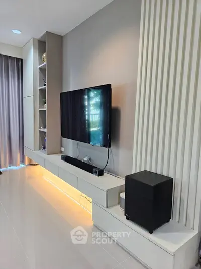 Modern living room with sleek TV setup and ambient lighting