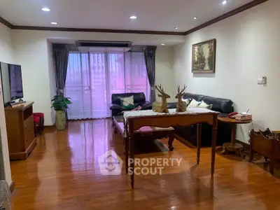 Spacious living room with elegant decor and large windows offering natural light.