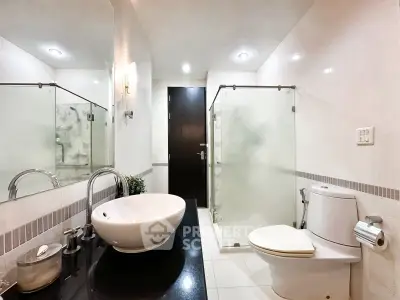 Modern bathroom with sleek fixtures and glass shower enclosure