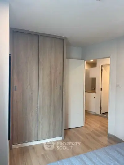 Modern bedroom with wooden wardrobe and sleek flooring