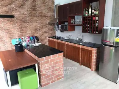 Charming kitchen with brick accents and modern appliances, perfect for culinary enthusiasts.