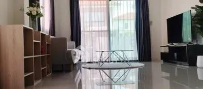 Modern living room with sleek furniture and large windows for natural light.