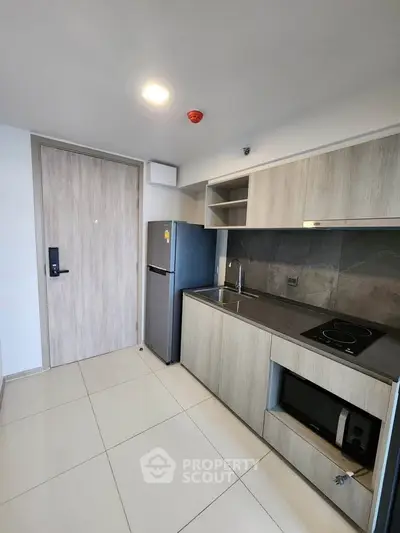 Modern kitchen with sleek cabinetry, built-in appliances, and minimalist design in a contemporary apartment.