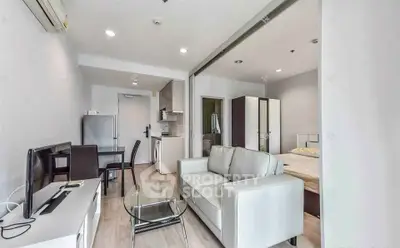 Modern open-plan living room with kitchen and bedroom in a stylish apartment