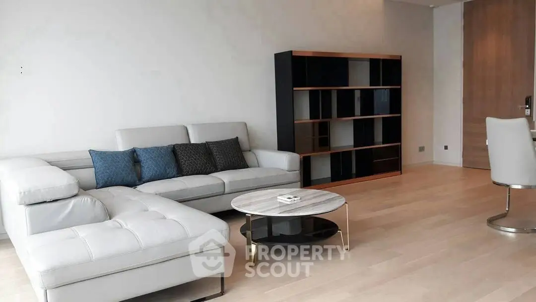 Modern living room with sleek furniture and elegant decor in a spacious apartment.