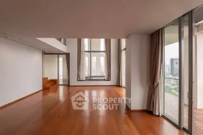 Spacious modern living room with floor-to-ceiling windows and city view