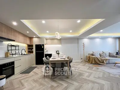 Spacious open-plan living and dining area with modern kitchen and stylish decor