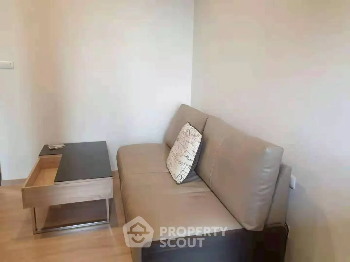Modern living room with sleek sofa and stylish coffee table in a cozy apartment.