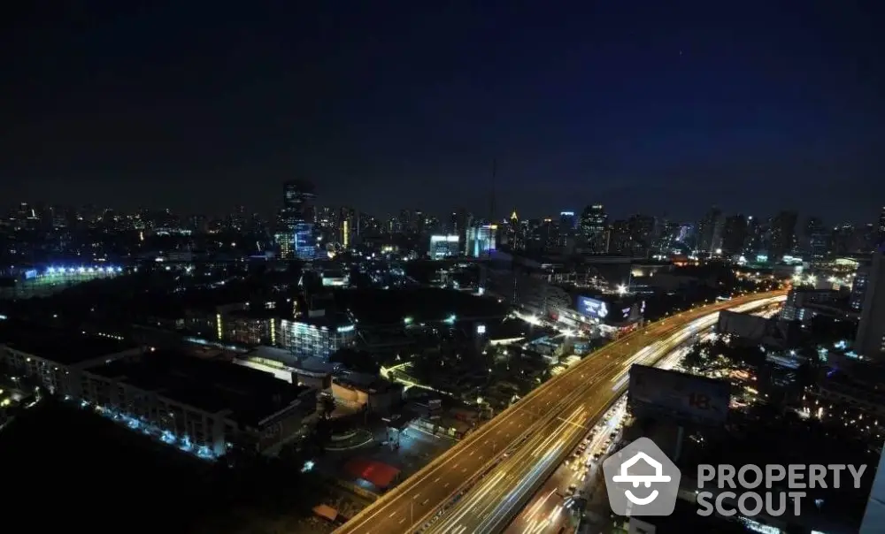 Stunning cityscape night view showcasing vibrant urban lights and bustling highway.