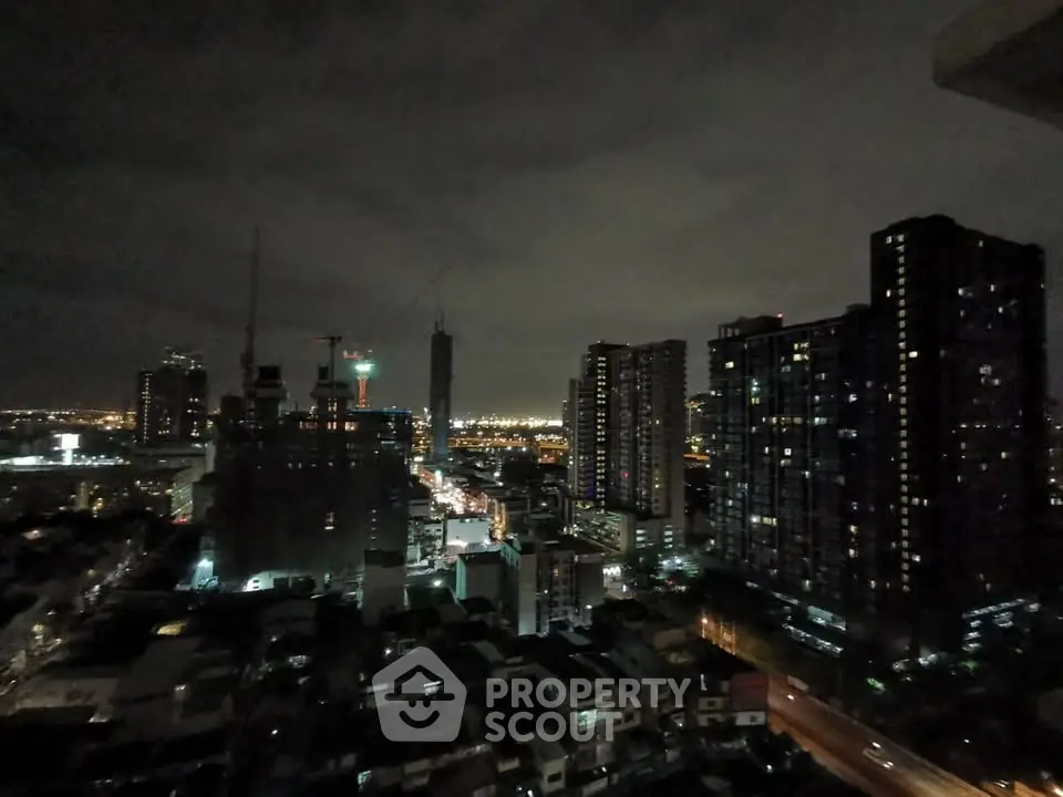 Stunning cityscape view from high-rise building at night, showcasing urban skyline and vibrant city lights.
