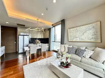 Luxurious modern living room with elegant decor and city view, featuring open kitchen and stylish dining area.