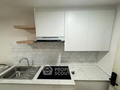 Modern kitchen with sleek white cabinets and marble countertops