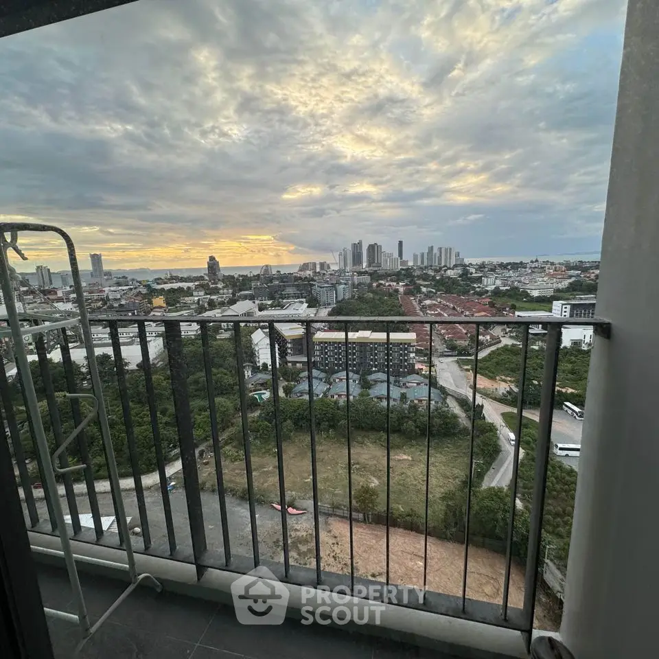 Stunning cityscape view from high-rise balcony at sunset, perfect for urban living.