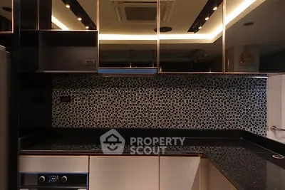 Modern kitchen with sleek black countertops and mosaic backsplash