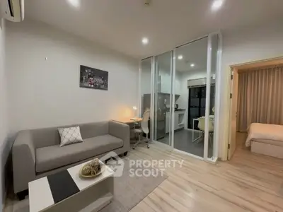 Modern living room with open kitchen and cozy bedroom in stylish apartment