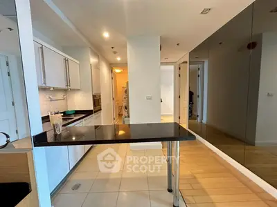 Modern kitchen with sleek design and open layout, featuring a stylish countertop and ample storage space.