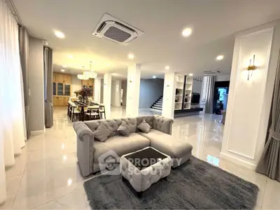 Luxurious open-plan living room with elegant decor and plush furniture in a modern home.