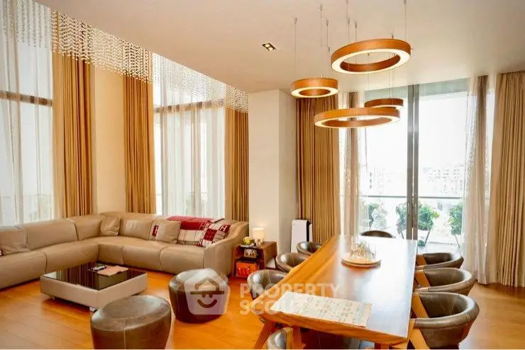 Luxurious modern living room with elegant lighting and large windows offering a stunning view.