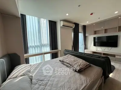 Modern bedroom with large windows, air conditioning, and wall-mounted TV in a stylish apartment.