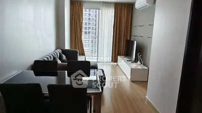 Modern living room with sleek furniture and large window offering city view