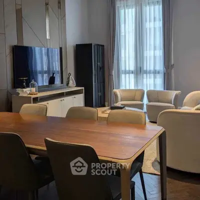 Elegant living room with modern furniture and large windows, perfect for entertaining guests.
