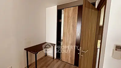 Compact study room with wooden flooring and modern sliding door
