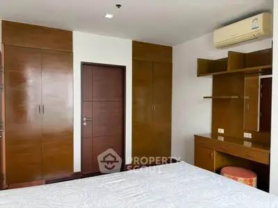 Spacious bedroom with built-in wardrobes and air conditioning unit
