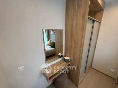 Modern bedroom with stylish wooden furniture and mirror, showcasing elegant interior design.