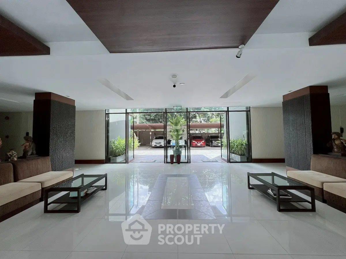 Spacious modern lobby with sleek design and natural light, perfect for welcoming guests.