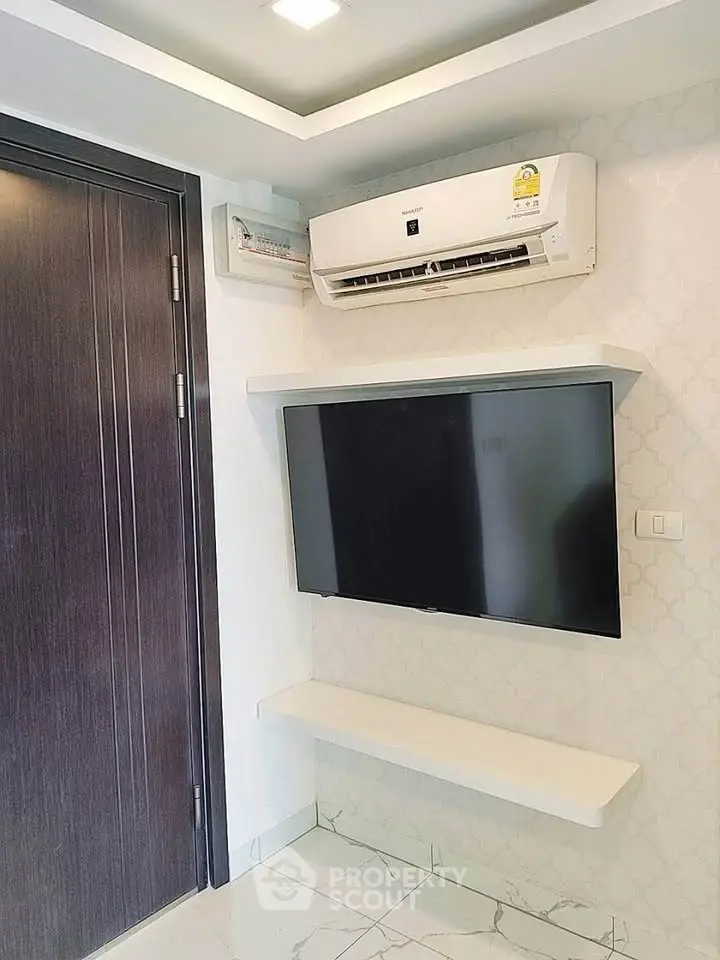 Modern interior with wall-mounted TV and air conditioning unit