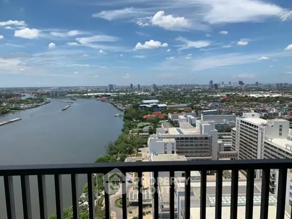 Stunning cityscape view from high-rise balcony overlooking river and skyline.