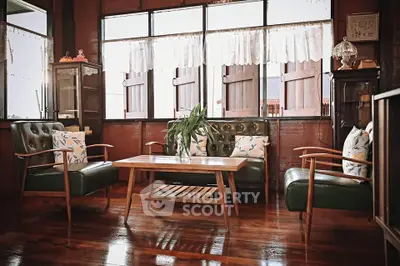 Charming vintage living room with wooden floors and classic furniture.
