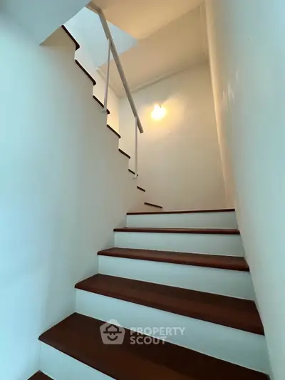 Elegant staircase with wooden steps and modern lighting in a stylish home