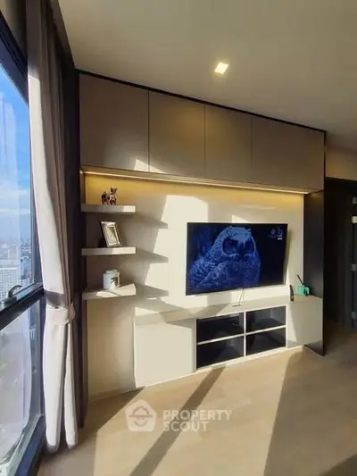 Modern living room with sleek TV unit and large window view