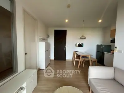 Modern living room with dining area and minimalist furniture in a cozy apartment.