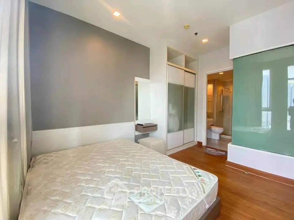 Modern bedroom with ensuite bathroom and built-in wardrobe in a stylish apartment.