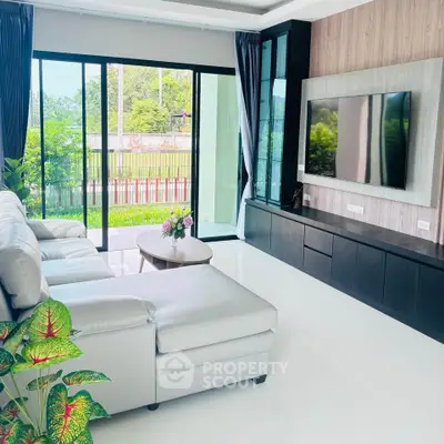 Spacious modern living room with large windows and sleek furniture.
