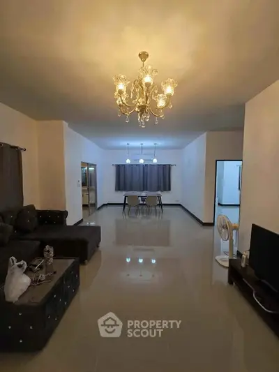 Spacious living room with elegant chandelier and modern decor