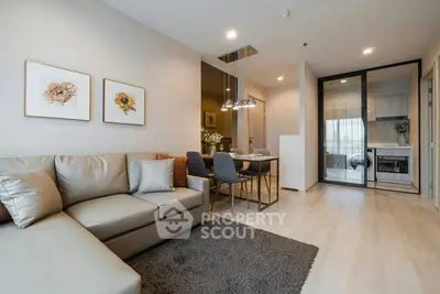 Modern living room with elegant decor and open kitchen layout in a stylish apartment.