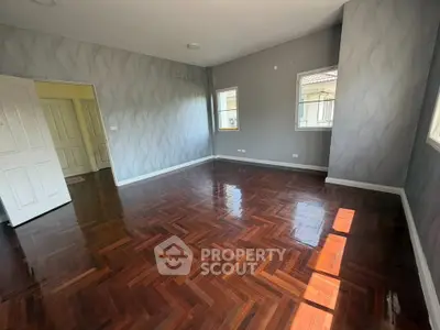 Spacious empty room with polished wooden floors and modern design