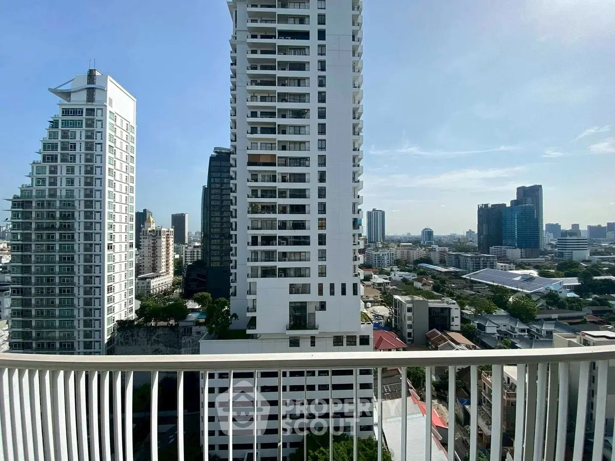 Stunning cityscape view from a high-rise balcony in a modern urban setting.