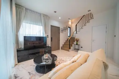 Modern living room with elegant staircase and stylish decor