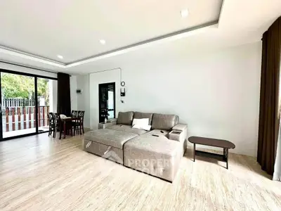 Spacious modern living room with large windows and elegant furniture, perfect for family gatherings.