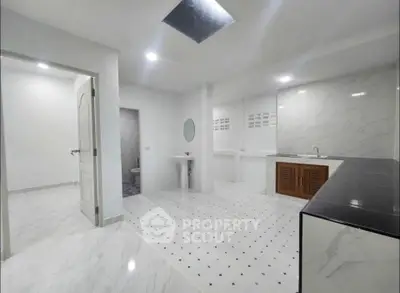 Spacious modern bathroom with elegant marble flooring and sleek fixtures
