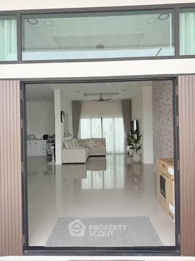 Spacious modern living room with sleek design and large windows for natural light.