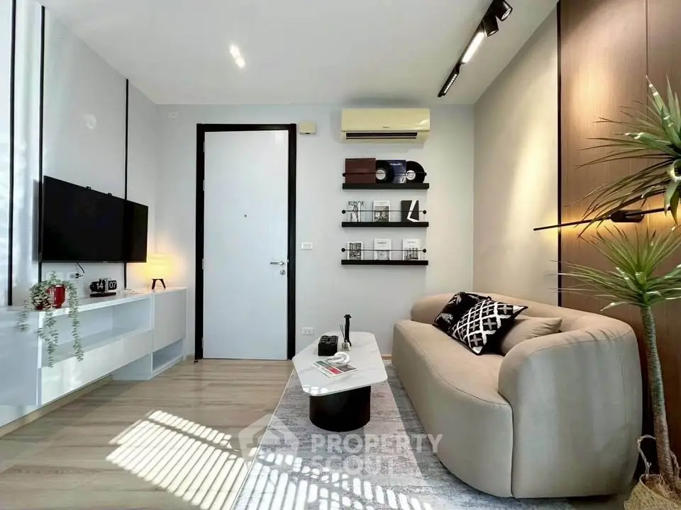 Modern living room with stylish decor and natural light, featuring a cozy sofa and sleek shelving.