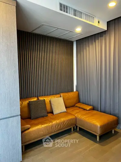 Stylish modern living room with leather sofa and elegant wall paneling